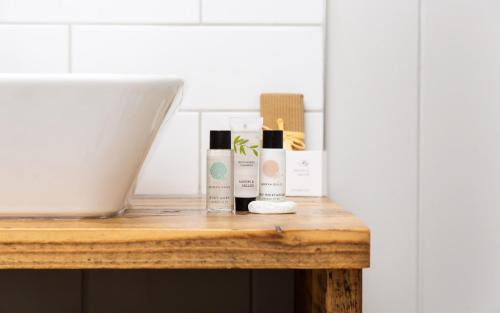 a table with three bottles of hair products on it at Willowbeck Lodge Boutique Hotel in Carlisle