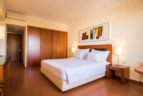 a large white bed in a hotel room at Vila Gale Cerro Alagoa in Albufeira