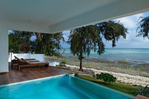 a swimming pool in a house with a view of the ocean at Nungwi Dreams by Mantis in Nungwi