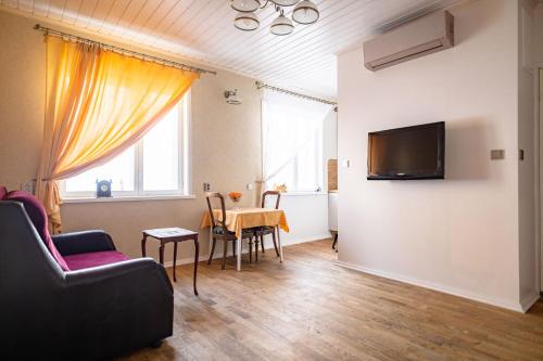 a living room with a couch and a table at Campenhausen lodging in the heart of Kuressaare in Kuressaare