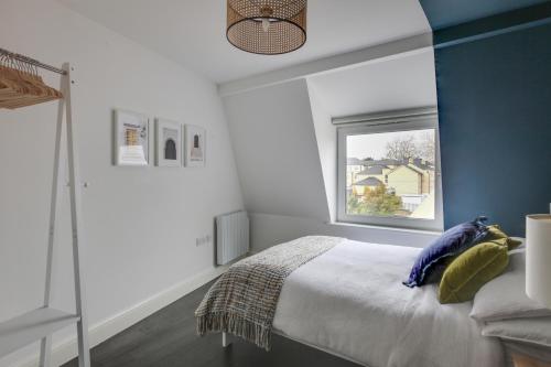 a bedroom with a bed and a window at Beautiful Chelmsford Apartment in Chelmsford