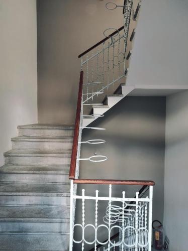 a staircase in a house with a metal railing at b&b Casa Livia in Pordenone