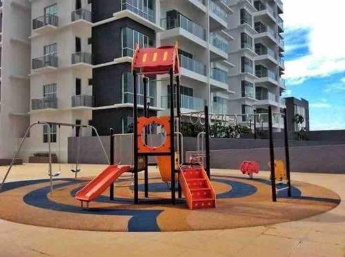 a playground in front of a apartment building at Shuang Yang Sekinchan Homestay 3 in Sekincan