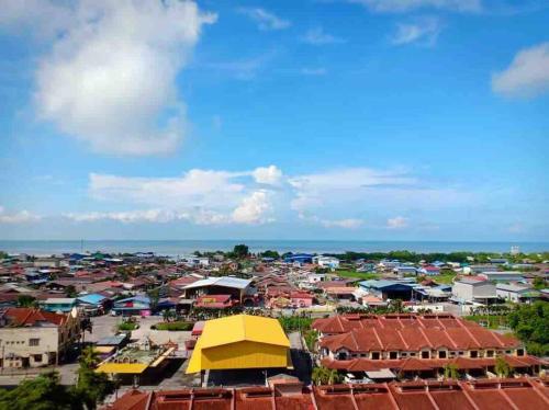 a view of a city with buildings and the ocean at Shuang Yang Sekinchan Homestay 3 in Sekincan