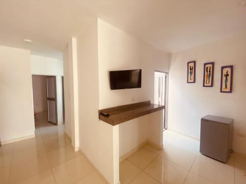 a living room with a flat screen tv on a wall at Mayo apartamentos in Santiago