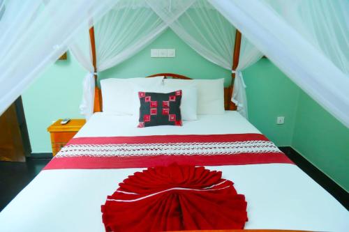 a bedroom with a bed with a red flower on it at King Lobster Summer House in Weligama