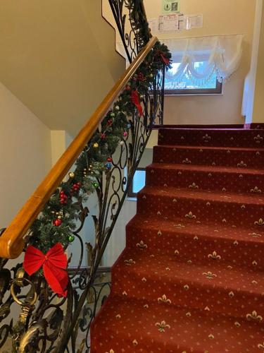 a staircase with a christmas wreath on the rail at Montebello in Predeal