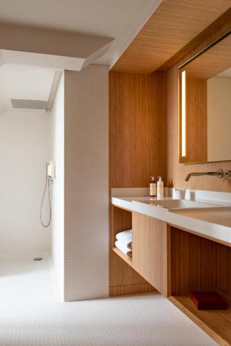 a bathroom with a sink and a mirror at Hotel Les Haras in Strasbourg