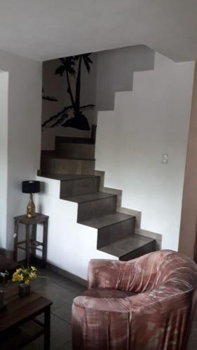 a living room with a staircase and a couch at Maganal in Villa Carlos Paz
