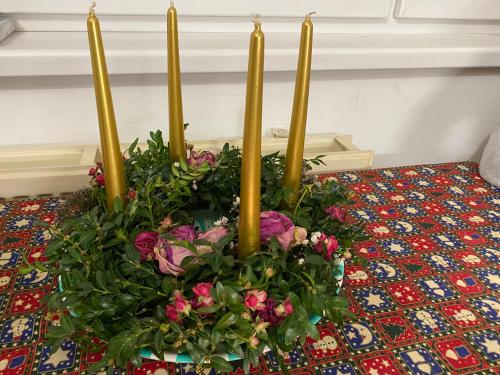 a display of flowers and candles in a flower arrangement at Slunný byt v Jizerských horách 5 postelí in Tanvald
