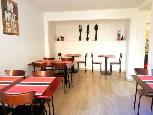 a restaurant with tables and chairs and utensils on the wall at Cascais Bela House in Cascais