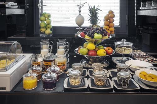 a kitchen counter with a bunch of fruits and jars of food at LHP Hotel Santa Margherita Palace & SPA in Santa Margherita Ligure