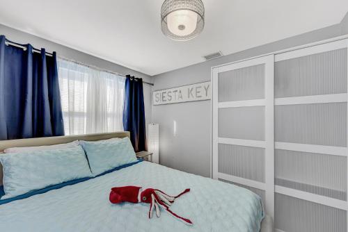a red purse sitting on a bed in a bedroom at Mermaid-Shark 6BR House With Pool, Jacuzzi - Steps to Siesta Key Beach in Siesta Key
