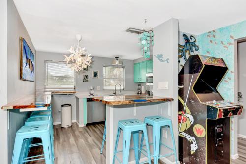 a kitchen with blue stools at a counter at Mermaid-Shark 6BR House With Pool, Jacuzzi - Steps to Siesta Key Beach in Siesta Key