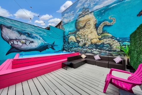 a mural on the side of a building with a pink bench at Mermaid-Shark 6BR House With Pool, Jacuzzi - Steps to Siesta Key Beach in Siesta Key