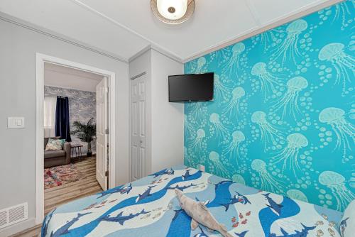 a bedroom with a blue wall with an octopus wallpaper at Mermaid-Shark 6BR House With Pool, Jacuzzi - Steps to Siesta Key Beach in Siesta Key