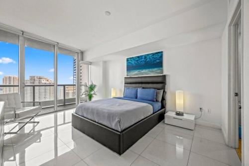 a bedroom with a bed and a view of the city at Inredible View -Luxury Unit at the W Brickell in Miami