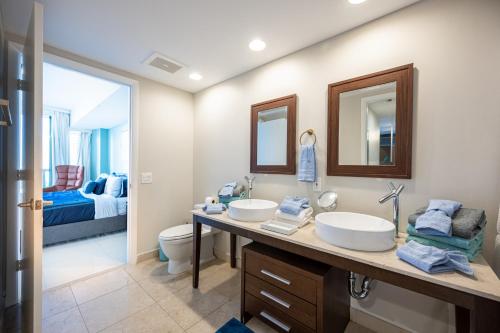 a bathroom with two sinks and a toilet at Inredible View -Luxury Unit at the W Brickell in Miami