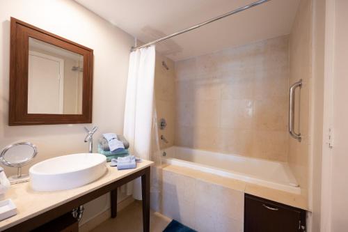 a bathroom with a sink and a bath tub at Inredible View -Luxury Unit at the W Brickell in Miami