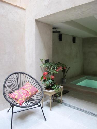 a chair with a pillow sitting next to a pool at CAN SAFRA in La Pera