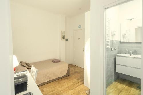 a small bedroom with a bed and a bathroom at GARDEN HOUSE - Luxury Guest House - Self check-in only in Rome