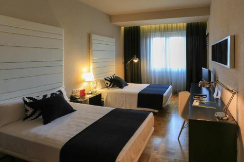 Postel nebo postele na pokoji v ubytování Habitus Hotel Leyre