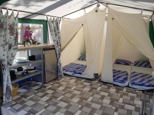 a tent with two beds in a room at Camping Planik in Ražanac