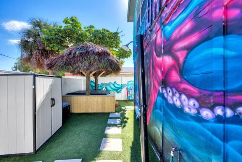 a mural on the side of a building with grass at Mermaid-Shark 6BR House With Pool, Jacuzzi - Steps to Siesta Key Beach in Siesta Key
