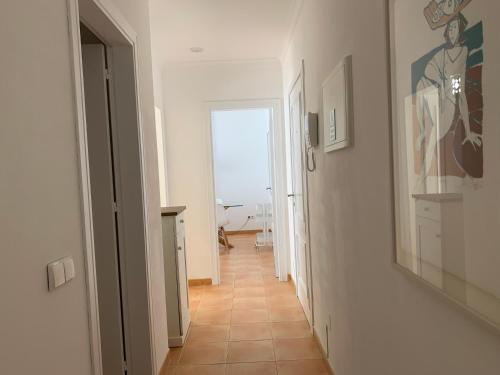 a hallway with a view of the ocean from a room at Monte Gordo Beach Flat with Balcony in Monte Gordo
