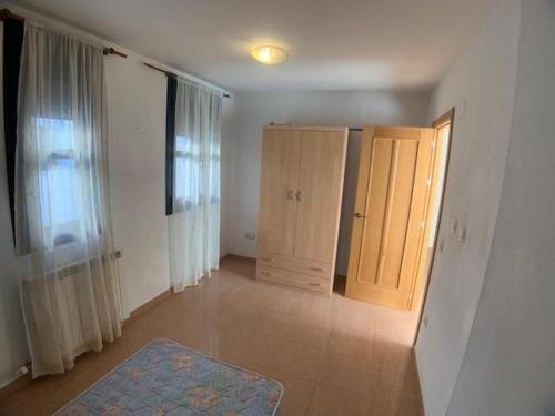 an empty room with two wooden doors and a hallway at VUT SEGEDA Valle del Manubles in Calatayud