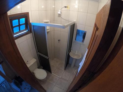 an overhead view of a bathroom with a toilet and a shower at Guaraflat in Guaratuba