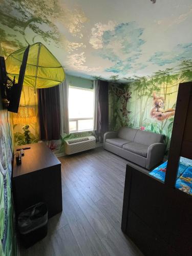 a living room with a painting on the ceiling at Super 8 by Wyndham Winnipeg East MB in Winnipeg