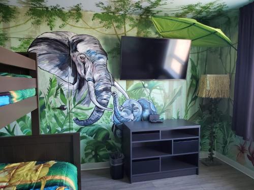 a bedroom with a mural of an elephant at Super 8 by Wyndham Winnipeg East MB in Winnipeg