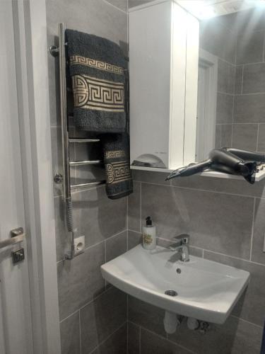 a bathroom with a sink and a mirror at Як вдома ! in Uzhhorod