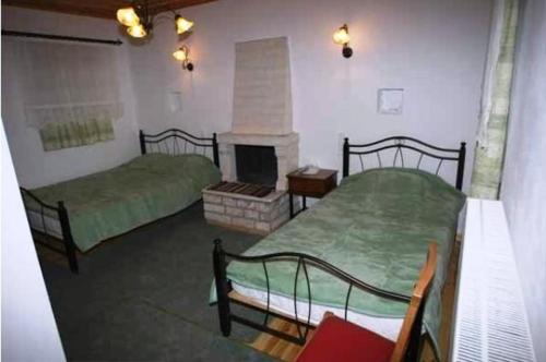 A bed or beds in a room at Terpsichori Guesthouse