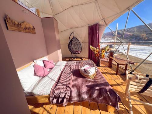 a bed in a tent on a boat at Glamping Park in Khndzorut