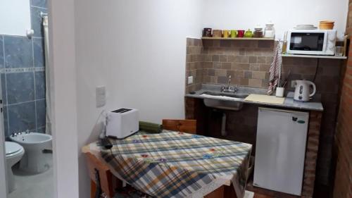 a small bathroom with a sink and a counter top at Peggy´s House in Puerto San Julián
