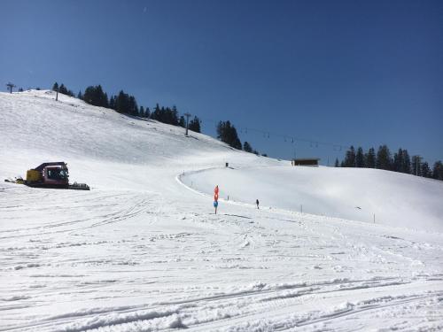 a person is standing on a snow covered slope at Landhaus Renata - Wendelstein in Bayrischzell