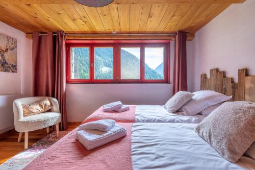 a bedroom with a large bed and a window at Chalet Solize - Terrasse avec superbe vue - Sauna in Champagny-en-Vanoise