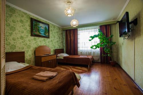 Una habitación de hotel con dos camas y un televisor. en Panska Hata, en Vínnytsia
