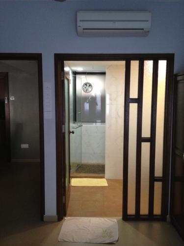 a door leading to a bathroom with a shower at Beach Resort Home Stay 25 Batu Ferringhi Penang in Batu Ferringhi
