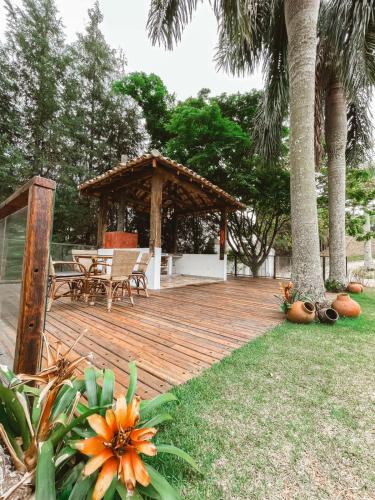 a wooden deck with a gazebo in a yard at Confraria Colonial Hotel Boutique in Mairinque