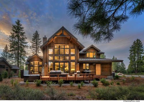 a large wooden house with glass windows at NEW 4BD Residence in the Signature Home Collection at Old Greenwood! in Truckee