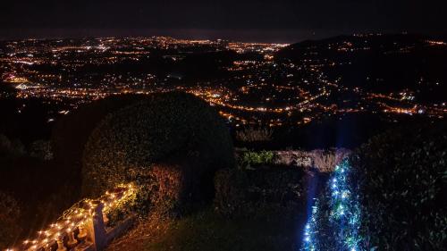 a view of a city at night with lights at Domaine du Bois d'Amont in Cabris