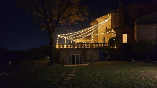 a house with christmas lights on it at night at Domaine du Bois d'Amont in Cabris
