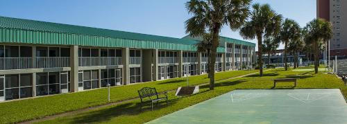 ein Gebäude mit Palmen davor in der Unterkunft Destin Holiday Beach Resort in Destin
