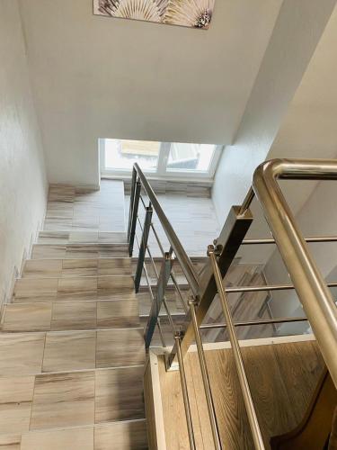 a staircase with metal railings and wood flooring at Під явором NEW in Drogomirchany