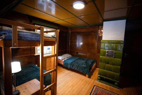 a room with two bunk beds in a boat at Rakouská vila in Bělá pod Pradědem