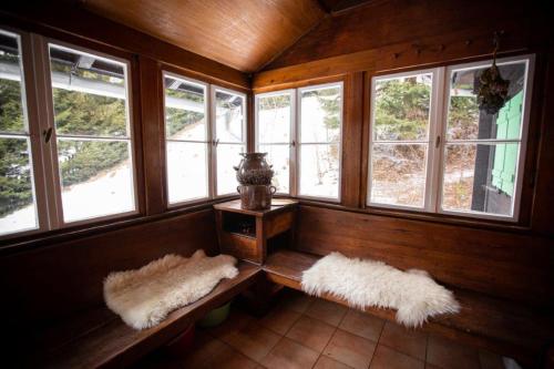 a room with two benches in a room with windows at Rakouská vila in Bělá pod Pradědem