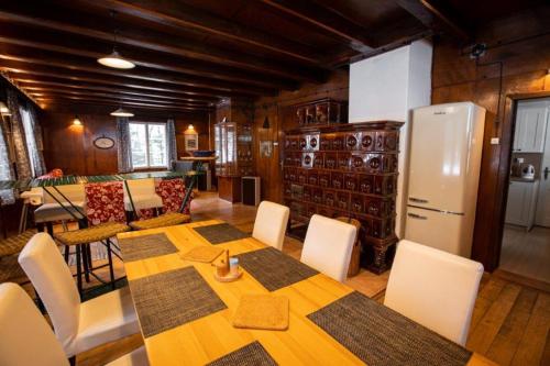 a dining room with a table and a refrigerator at Rakouská vila in Bělá pod Pradědem